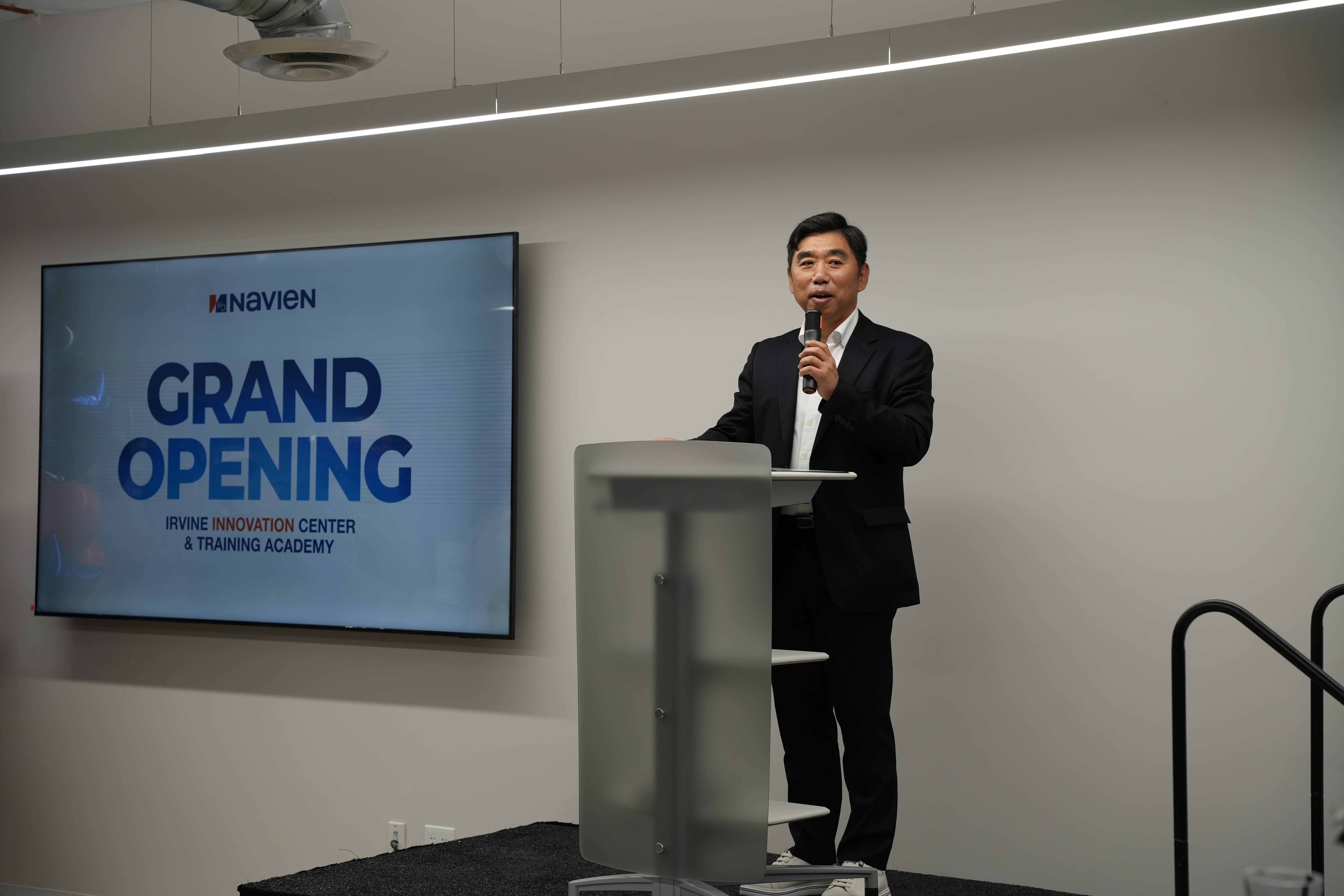 Navien CEO, TH Kim, at the podium during the grand opening ceremony of the Navien Irvine Innovation Center & Training Academy